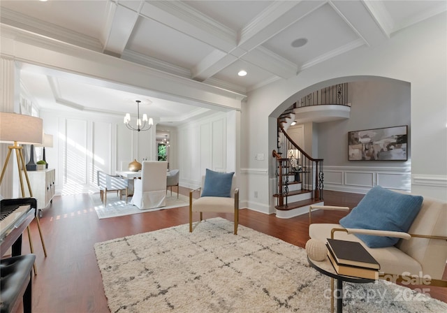 3015 Stanbury Dr, Matthews, NC 28104 - living area with arched walkways, wood finished floors, beam ceiling, a chandelier, and stairs