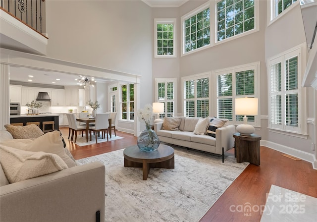 3015 Stanbury Dr, Matthews, NC 28104 - living room with a towering ceiling, wood finished floors, and ornamental molding
