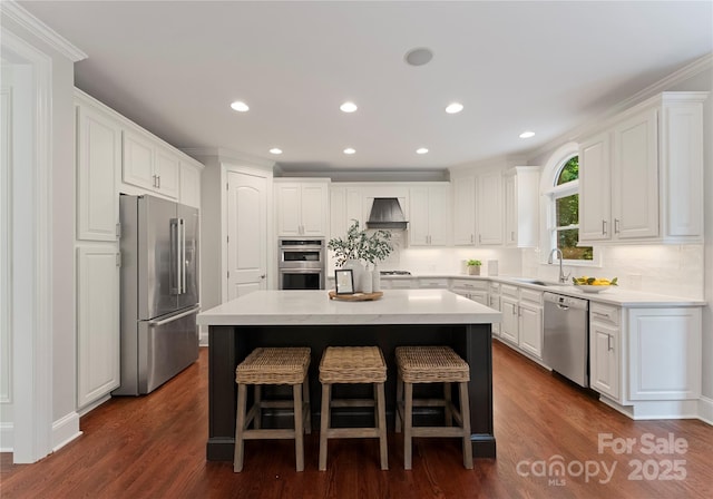 3015 Stanbury Dr, Matthews, NC 28104 - kitchen featuring appliances with stainless steel finishes, a center island, premium range hood, a breakfast bar, and white cabinetry