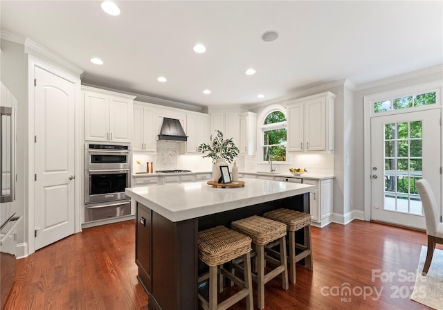 3015 Stanbury Dr, Matthews, NC 28104 - kitchen with a warming drawer, crown molding, premium range hood, double oven, and light countertops
