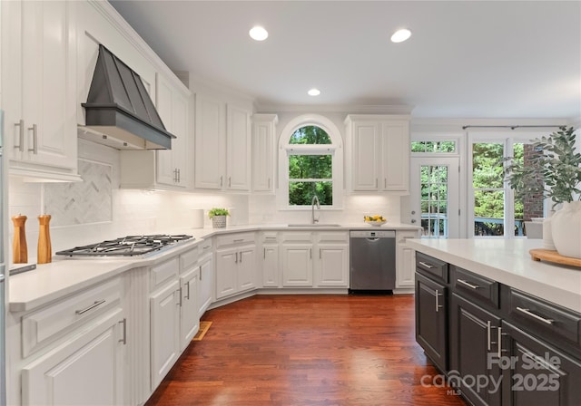 3015 Stanbury Dr, Matthews, NC 28104 - kitchen featuring appliances with stainless steel finishes, custom exhaust hood, plenty of natural light, white cabinets, and recessed lighting