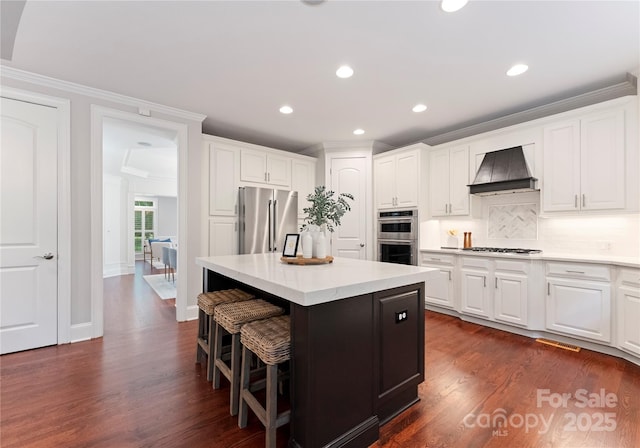 3015 Stanbury Dr, Matthews, NC 28104 - kitchen with stainless steel appliances, premium range hood, crown molding, a center island, and white cabinets