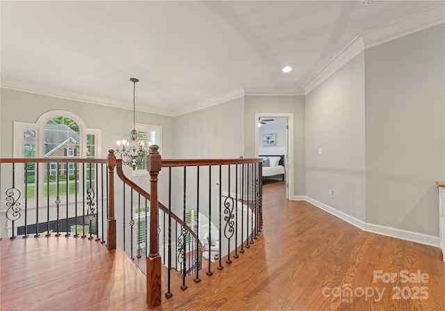 3015 Stanbury Dr, Matthews, NC 28104 - hallway featuring an upstairs landing, wood finished floors, a chandelier, recessed lighting, and crown molding