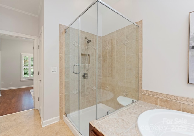 3015 Stanbury Dr, Matthews, NC 28104 - bathroom featuring a stall shower, crown molding, tile patterned flooring, and a bath