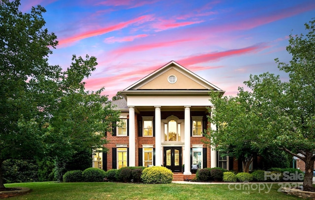 3015 Stanbury Dr, Matthews, NC 28104 - greek revival inspired property with french doors, a lawn, and brick siding