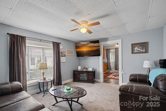 74 Meadow Ave, Concord, NC 28025 - living area with ceiling fan, a paneled ceiling, and carpet