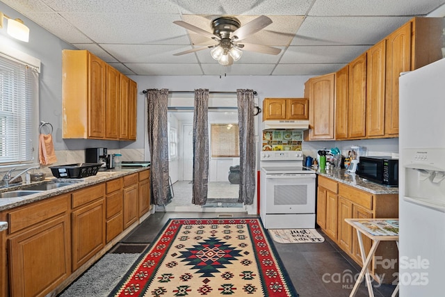 74 Meadow Ave, Concord, NC 28025 - kitchen featuring white appliances, a paneled ceiling, ceiling fan, under cabinet range hood, and brown cabinets