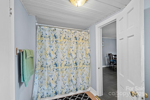 74 Meadow Ave, Concord, NC 28025 - bathroom featuring tile patterned floors, curtained shower, and a textured ceiling