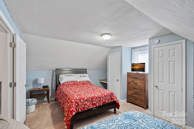 74 Meadow Ave, Concord, NC 28025 - bedroom with carpet floors, lofted ceiling, and a textured ceiling