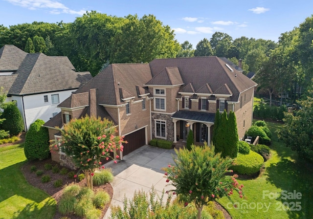 202 Montrose Dr, Waxhaw, NC 28173 - view of front of home featuring driveway, an attached garage, stone siding, and a front yard