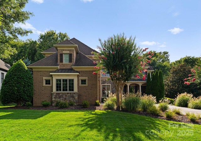 202 Montrose Dr, Waxhaw, NC 28173 - view of front of property featuring a front yard, a shingled roof, stone siding, brick siding, and a standing seam roof