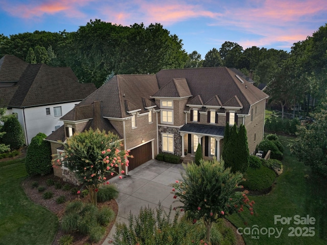 202 Montrose Dr, Waxhaw, NC 28173 - view of front facade with concrete driveway, stone siding, and an attached garage