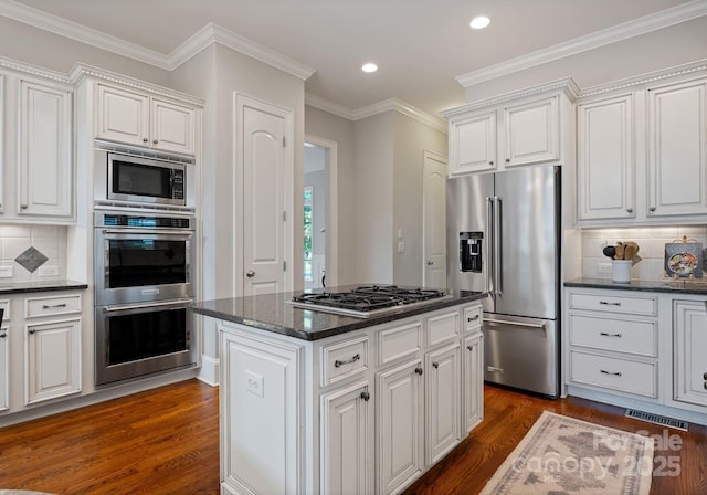202 Montrose Dr, Waxhaw, NC 28173 - kitchen featuring appliances with stainless steel finishes, dark wood-style floors, white cabinetry, backsplash, and recessed lighting