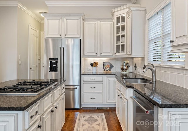 202 Montrose Dr, Waxhaw, NC 28173 - kitchen featuring stainless steel appliances, glass insert cabinets, decorative backsplash, dark wood-style flooring, and crown molding