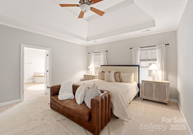 202 Montrose Dr, Waxhaw, NC 28173 - bedroom featuring a tray ceiling, multiple windows, crown molding, light carpet, and ensuite bath
