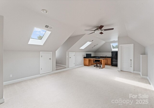 202 Montrose Dr, Waxhaw, NC 28173 - unfurnished office with a skylight, lofted ceiling, light carpet, and a ceiling fan