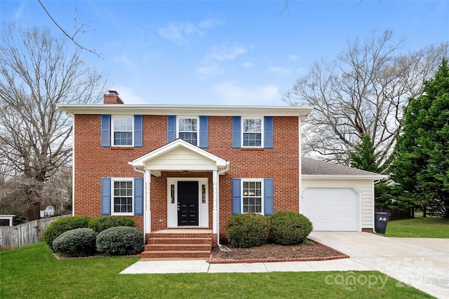 8749 Rittenhouse Cir, Charlotte, NC 28270 - colonial house with driveway, a chimney, an attached garage, and brick siding