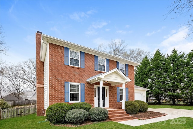 8749 Rittenhouse Cir, Charlotte, NC 28270 - colonial inspired home with brick siding, driveway, a garage, and a chimney