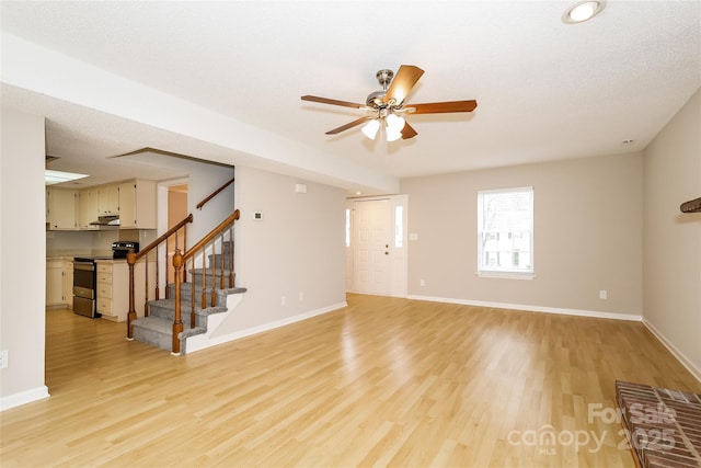 8749 Rittenhouse Cir, Charlotte, NC 28270 - unfurnished living room featuring stairway, light wood finished floors, and a ceiling fan