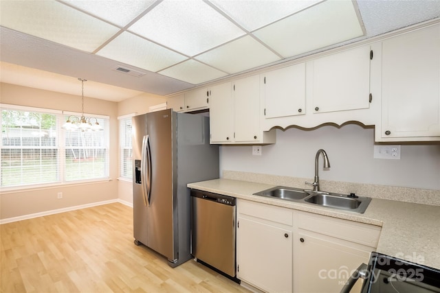 8749 Rittenhouse Cir, Charlotte, NC 28270 - kitchen featuring appliances with stainless steel finishes, a chandelier, light wood-type flooring, light countertops, and decorative light fixtures
