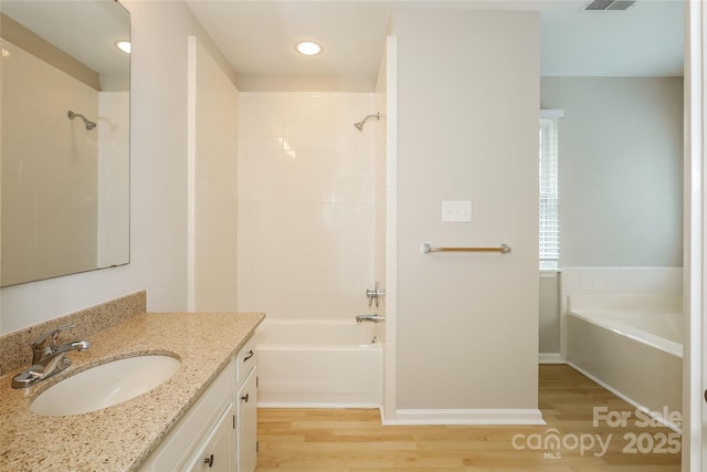8749 Rittenhouse Cir, Charlotte, NC 28270 - bathroom with vanity, wood finished floors, recessed lighting, and shower / tub combination