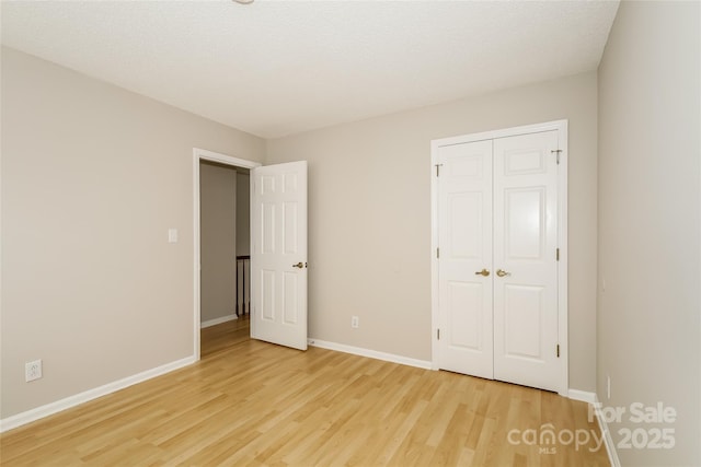8749 Rittenhouse Cir, Charlotte, NC 28270 - unfurnished bedroom with light wood finished floors and a closet