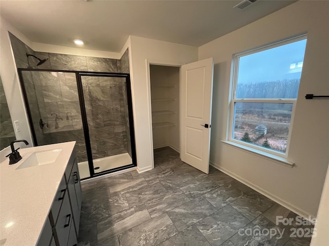 435 Lancashire Ct, Denver, NC 28037 - full bathroom featuring vanity, a shower stall, healthy amount of natural light, and marble look tile flooring