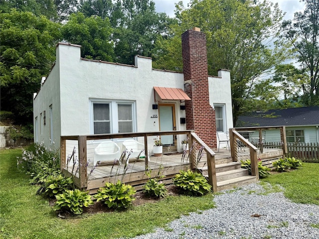 355 Walnut Ave, Spruce Pine, NC 28777 - view of front facade featuring stucco siding, a chimney, a deck, a standing seam roof, and a front lawn
