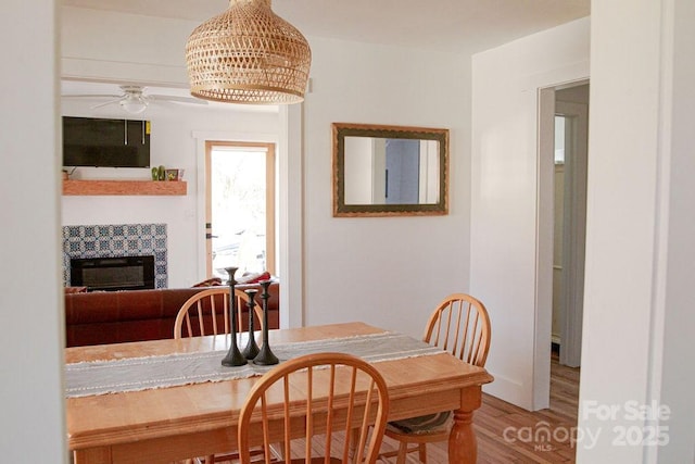 355 Walnut Ave, Spruce Pine, NC 28777 - dining area with wood finished floors, ceiling fan, and a fireplace