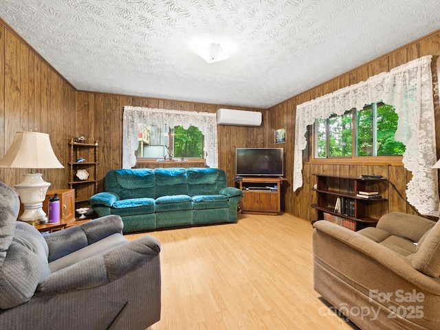 1400 Watershed Rd, Mars Hill, NC 28754 - living area with a wall mounted air conditioner, wooden walls, wood finished floors, and a textured ceiling