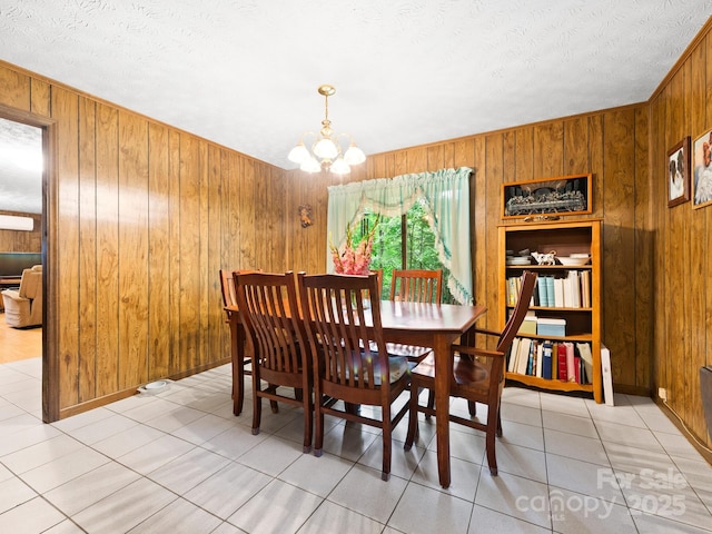 1400 Watershed Rd, Mars Hill, NC 28754 - dining room featuring wood walls, a textured ceiling, a chandelier, and light tile patterned floors