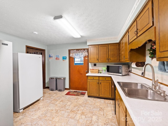 1400 Watershed Rd, Mars Hill, NC 28754 - kitchen featuring freestanding refrigerator, light countertops, brown cabinetry, a textured ceiling, and light stone finish floors
