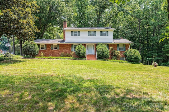 3781 Dover St, Claremont, NC 28610 - view of front of home featuring a chimney, a front lawn, and brick siding