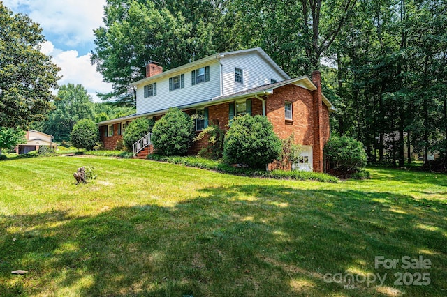 3781 Dover St, Claremont, NC 28610 - traditional home featuring a chimney, brick siding, a front yard, and a garage