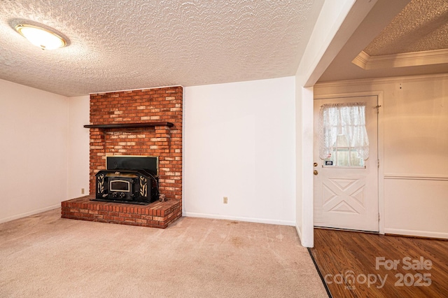 3781 Dover St, Claremont, NC 28610 - unfurnished living room featuring a textured ceiling, a wood stove, and crown molding