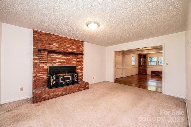 3781 Dover St, Claremont, NC 28610 - unfurnished living room featuring carpet floors, a textured ceiling, and a wood stove