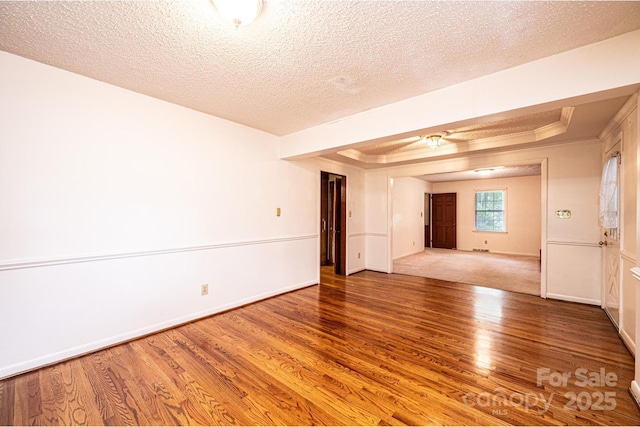 3781 Dover St, Claremont, NC 28610 - unfurnished room featuring wood finished floors, a tray ceiling, a textured ceiling, and ceiling fan