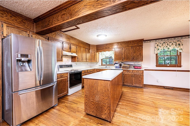 3781 Dover St, Claremont, NC 28610 - kitchen featuring stainless steel fridge, white range with electric cooktop, light countertops, a kitchen island, and a textured ceiling