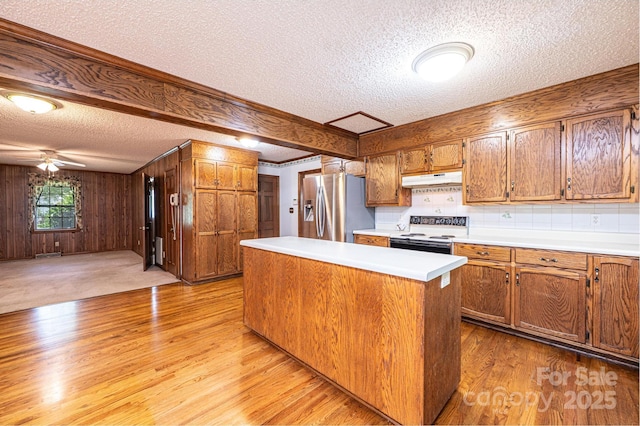 3781 Dover St, Claremont, NC 28610 - kitchen featuring stainless steel fridge with ice dispenser, white range with electric stovetop, a textured ceiling, under cabinet range hood, and light wood-style floors