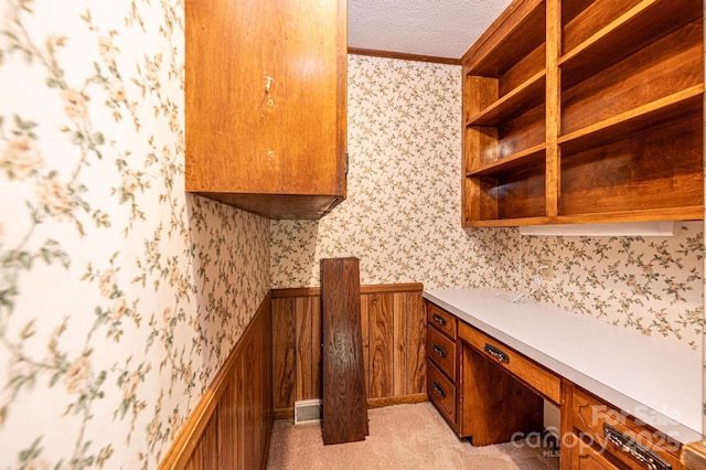 3781 Dover St, Claremont, NC 28610 - kitchen with wallpapered walls, crown molding, built in study area, brown cabinets, and open shelves
