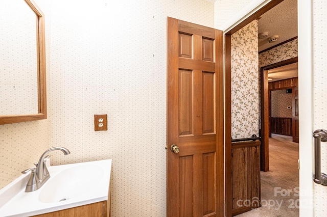 3781 Dover St, Claremont, NC 28610 - bathroom featuring wallpapered walls and vanity