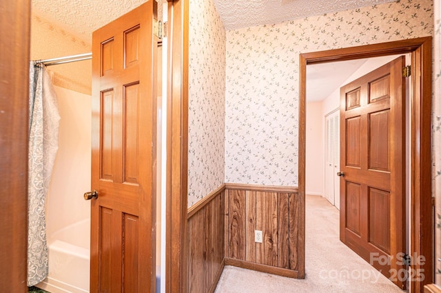3781 Dover St, Claremont, NC 28610 - hallway featuring wallpapered walls, a wainscoted wall, a textured ceiling, and carpet