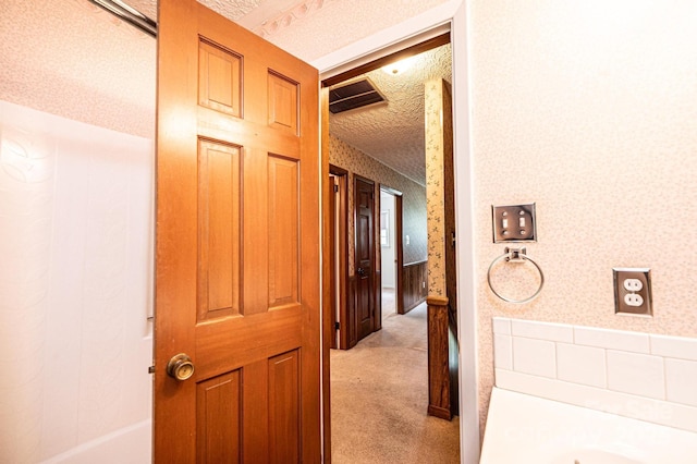 3781 Dover St, Claremont, NC 28610 - corridor featuring wallpapered walls, light colored carpet, and a textured ceiling