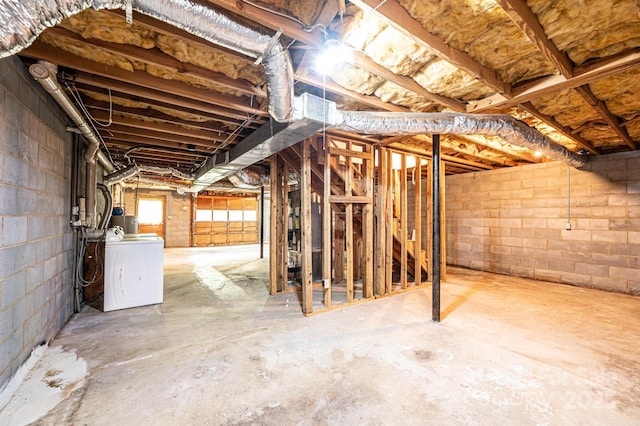 3781 Dover St, Claremont, NC 28610 - below grade area featuring separate washer and dryer and concrete block wall