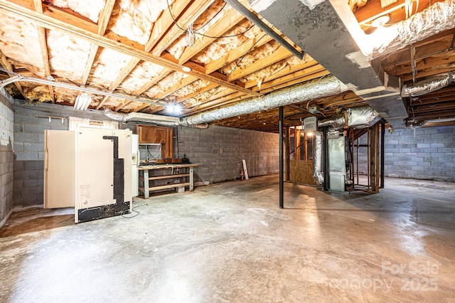 3781 Dover St, Claremont, NC 28610 - unfinished below grade area featuring fridge and concrete block wall