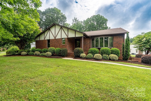 614 Azalea Ln, China Grove, NC 28023 - view of front of house featuring brick siding, a front lawn, and roof with shingles