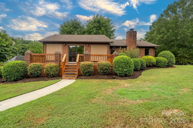 614 Azalea Ln, China Grove, NC 28023 - view of front of home with brick siding, a chimney, a deck, and a front lawn