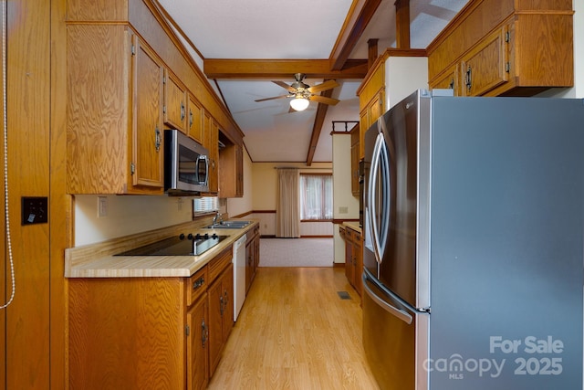 614 Azalea Ln, China Grove, NC 28023 - kitchen with appliances with stainless steel finishes, light wood-style flooring, beamed ceiling, ceiling fan, and brown cabinetry