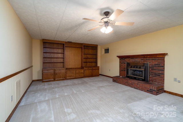 614 Azalea Ln, China Grove, NC 28023 - unfurnished living room with light carpet, built in shelves, ceiling fan, and a fireplace