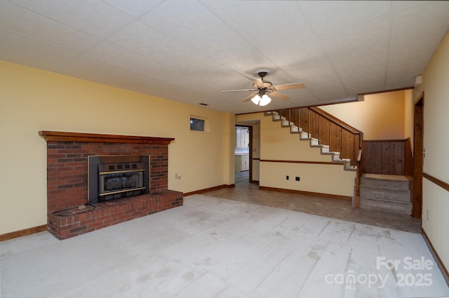 614 Azalea Ln, China Grove, NC 28023 - unfurnished living room featuring stairs, a fireplace, ceiling fan, and carpet floors